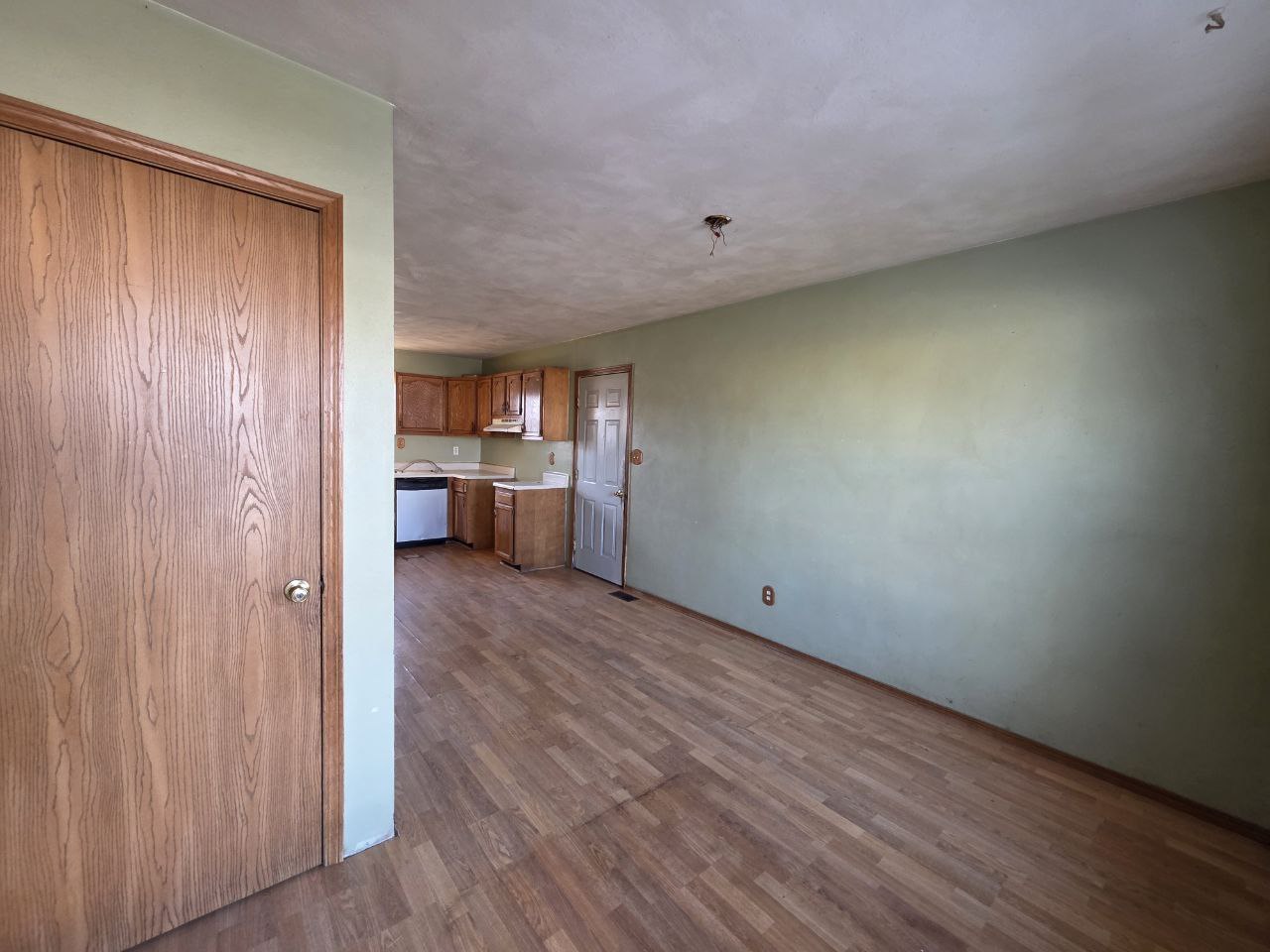 310 West 4th S Street Mount Olive, IL 62069 - Photo 4 of 10 a view of empty room with wooden floor and cabinet