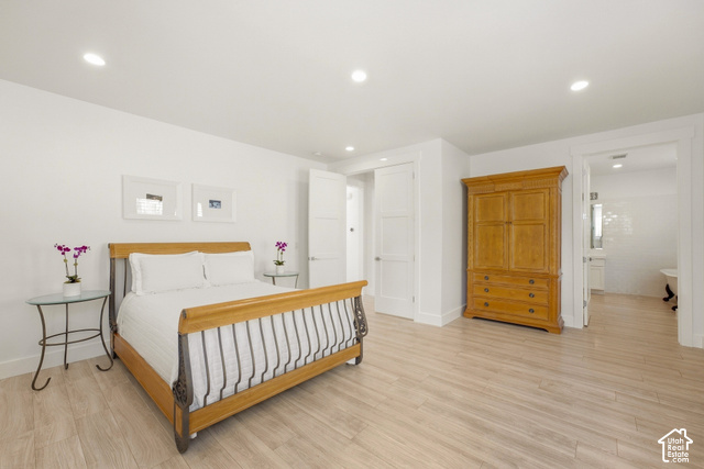 369 East Overlook Loop Kamas, UT 84036 - Photo 33 of 64 Recessed lighting, wood-finish flooring, white paneled doors, and a tiled bathroom with a freestanding tub