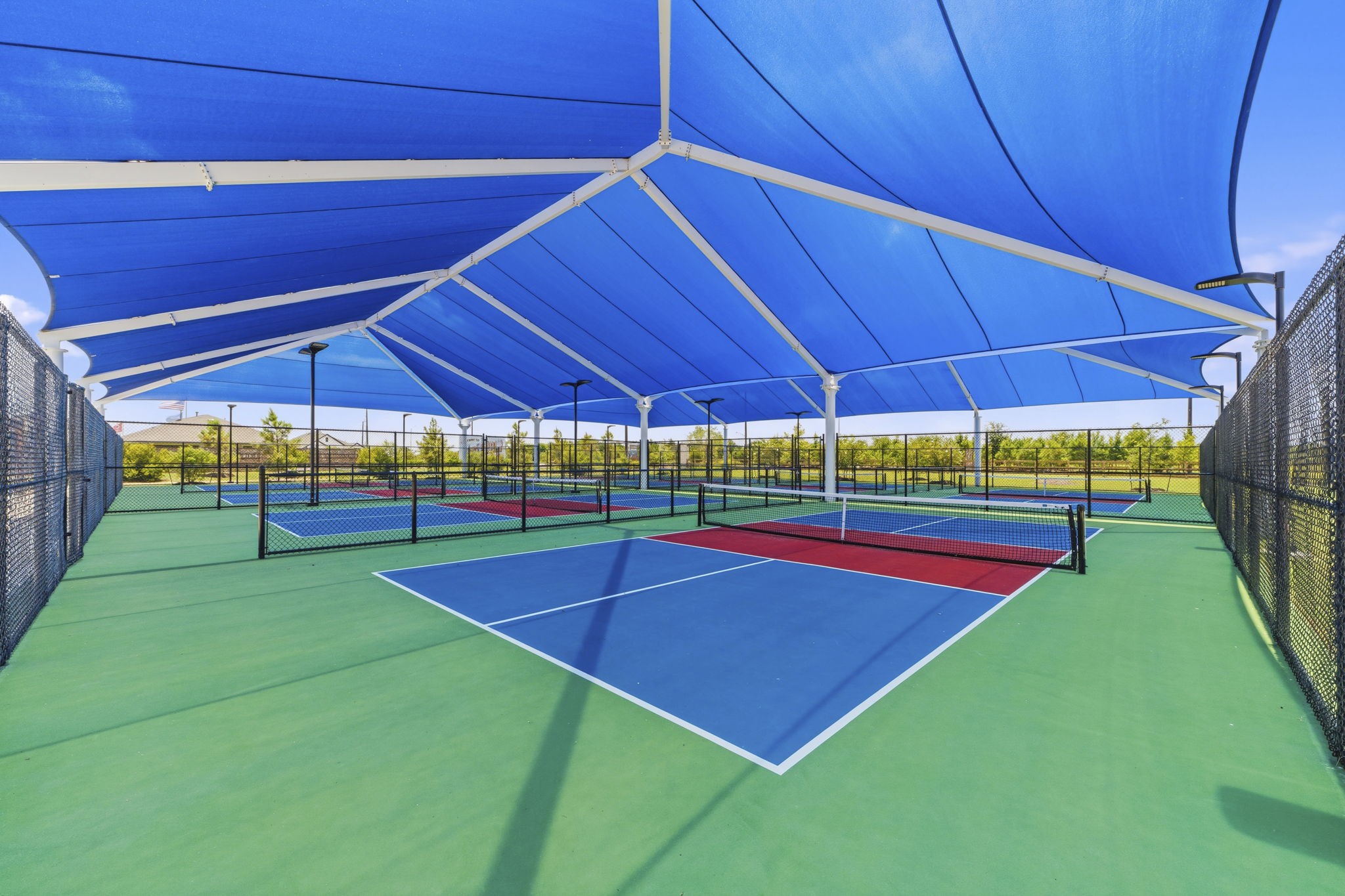 10934 Bonfire Trail Beasley, TX 77417 - Photo 27 of 32 Covered pickleball courts provide year-round play for all skill levels.