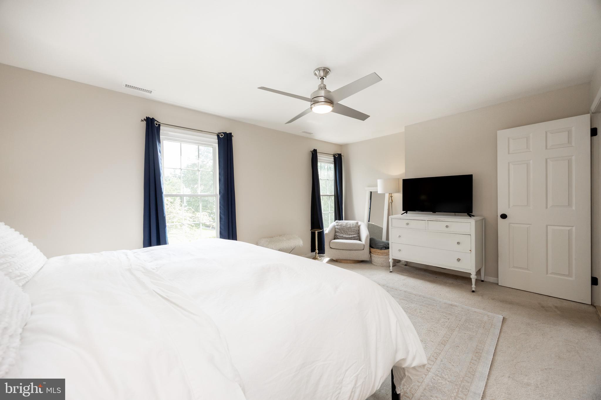 101 Ashley Road Phoenixville, PA 19460 - Photo 20 of 41 a bedroom with a bed a flat screen tv and a window