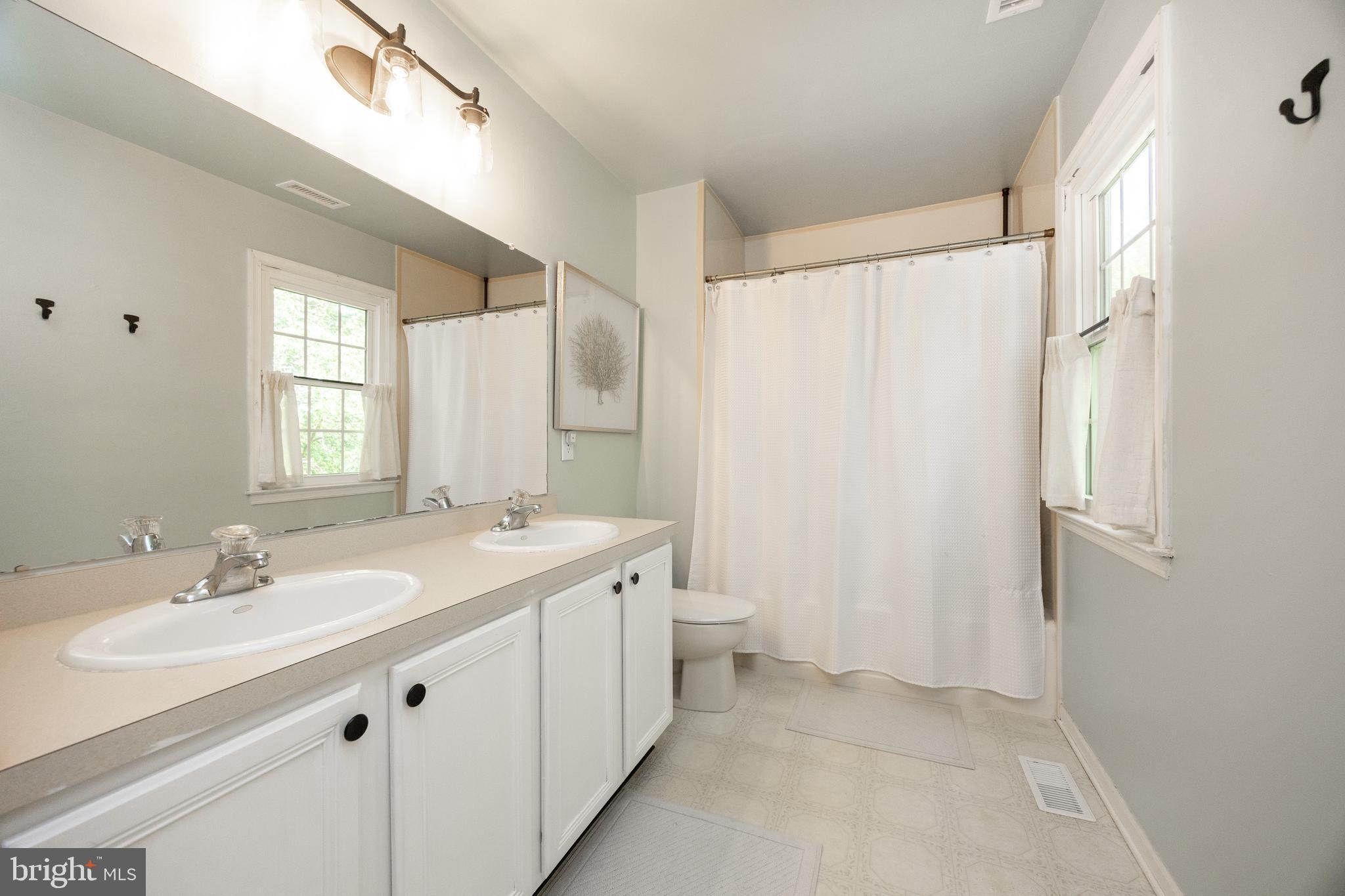 101 Ashley Road Phoenixville, PA 19460 - Photo 22 of 41 a bathroom with a double vanity sink and mirror with shower