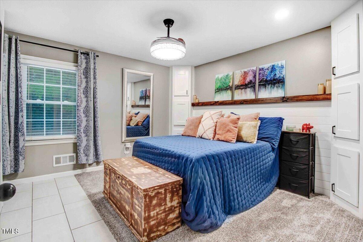 7509 Fiesta Way Raleigh, NC 27615 - Photo 25 of 56 a bedroom with a bed and a dresser