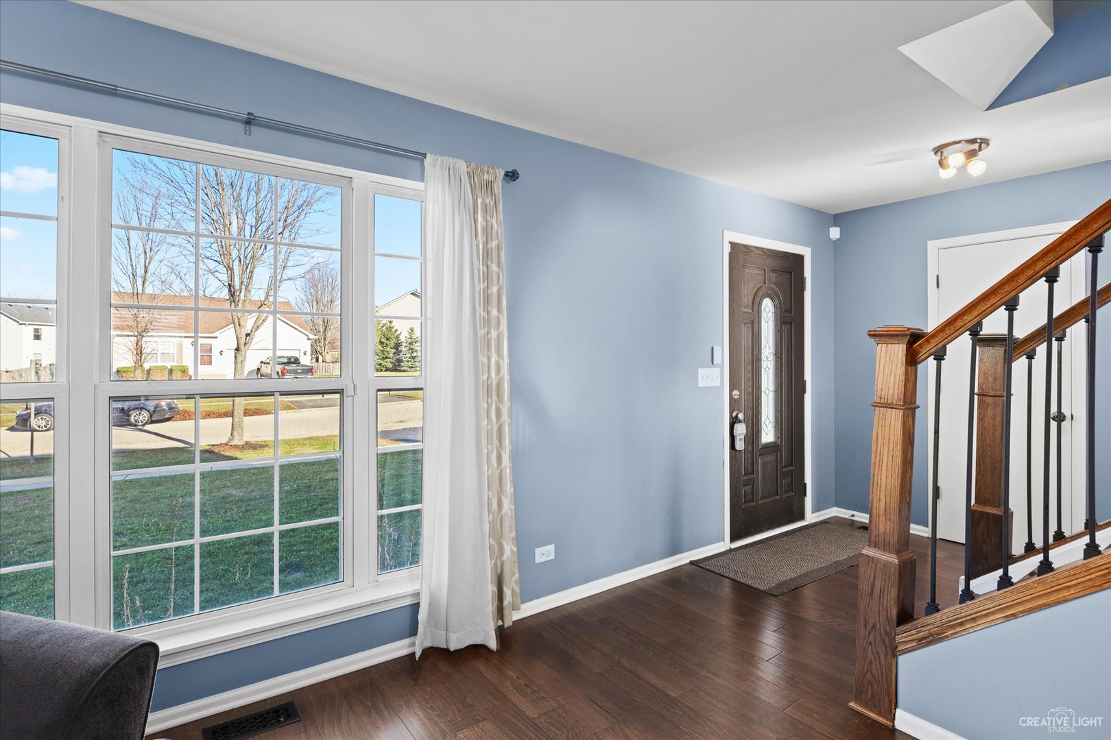 4020 Foli Street Plano, IL 60545 - Photo 2 of 17 a view of an empty room with wooden floor and windows