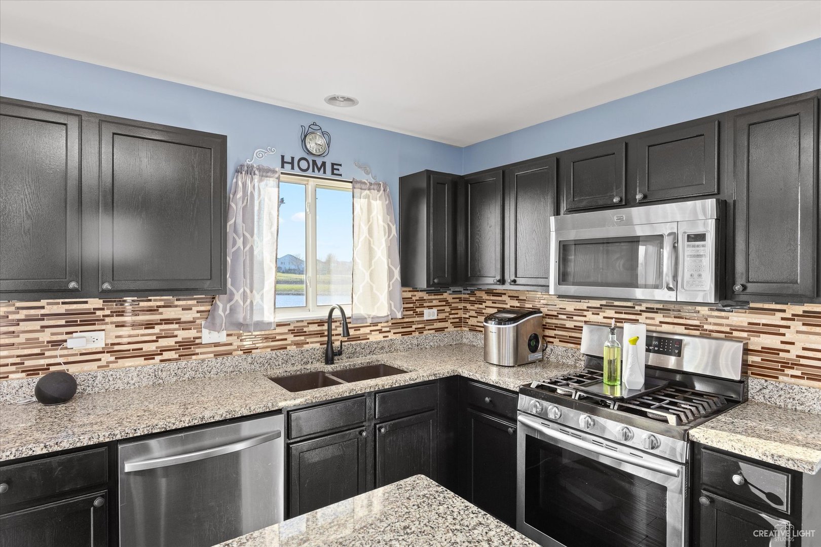 4020 Foli Street Plano, IL 60545 - Photo 6 of 17 a kitchen with stainless steel appliances granite countertop a sink stove and cabinets