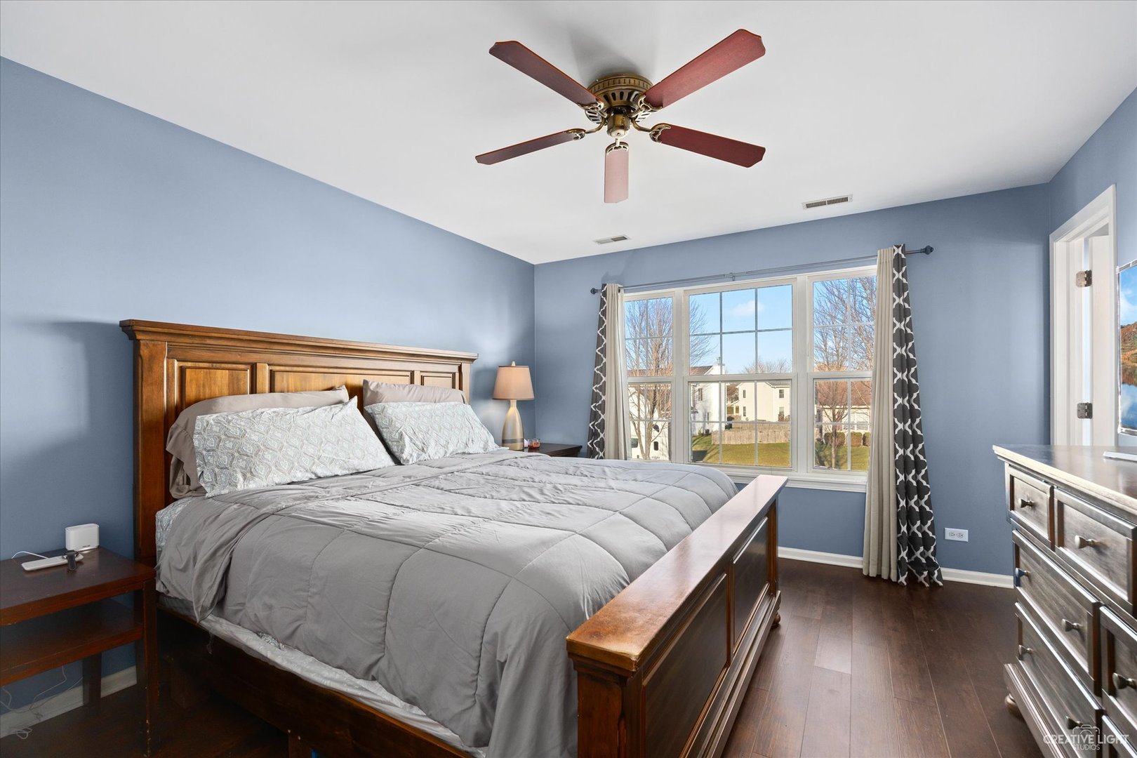 4020 Foli Street Plano, IL 60545 - Photo 10 of 17 a bedroom with a bed a window and a chandelier