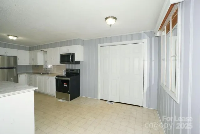 a kitchen with stainless steel appliances granite countertop a refrigerator sink and stove
