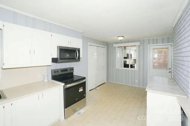 a kitchen with a refrigerator stove and microwave