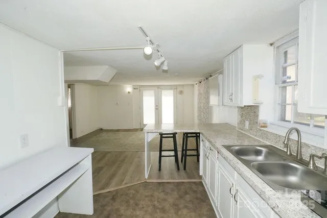 a kitchen filled counter top space a sink and appliances