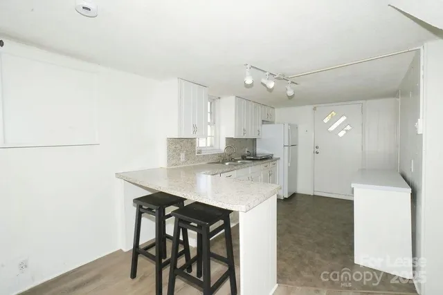 a kitchen with a table and chairs in it