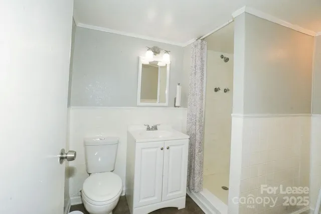 a bathroom with a toilet a sink and shower
