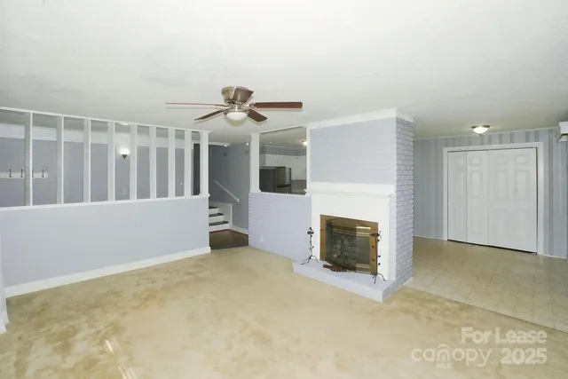 a view of an empty room with a fireplace