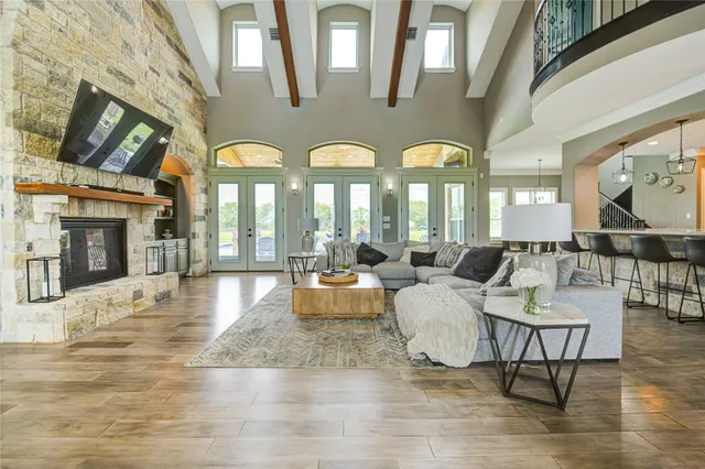 a living room with couches and a large mirror with potted plants