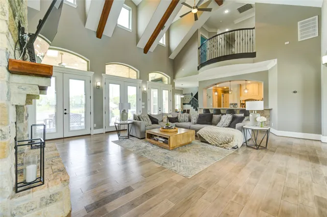 a living room with fireplace furniture and a large window