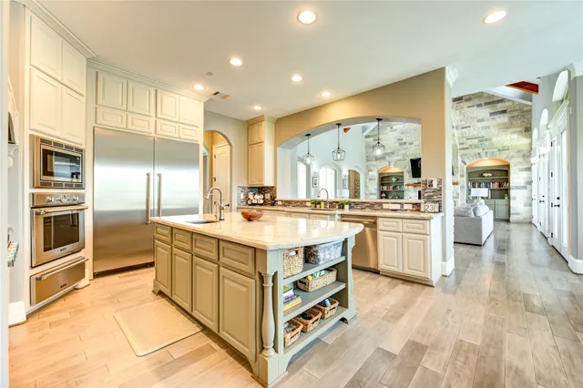a dining room with furniture a chandelier and wooden floor