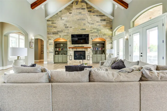 a living room with patio furniture and a dining table next to a window
