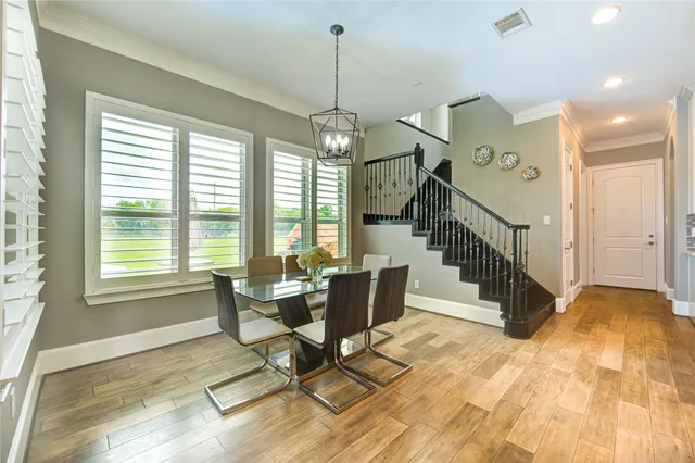 a bedroom with furniture and a large window