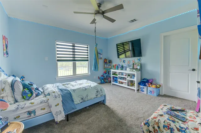 a bedroom with bed and window