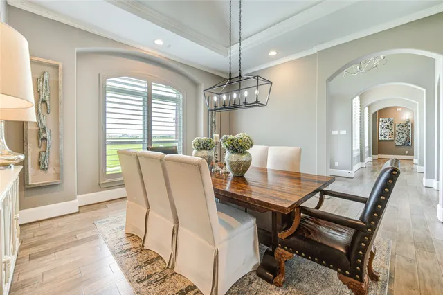a view of a dining room with furniture and chandelier