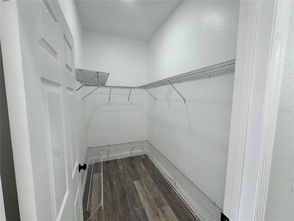 12757 Southeast 104th Terrace Belleview, FL 34420 - Photo 18 of 22 a view of a room with racks on the wall