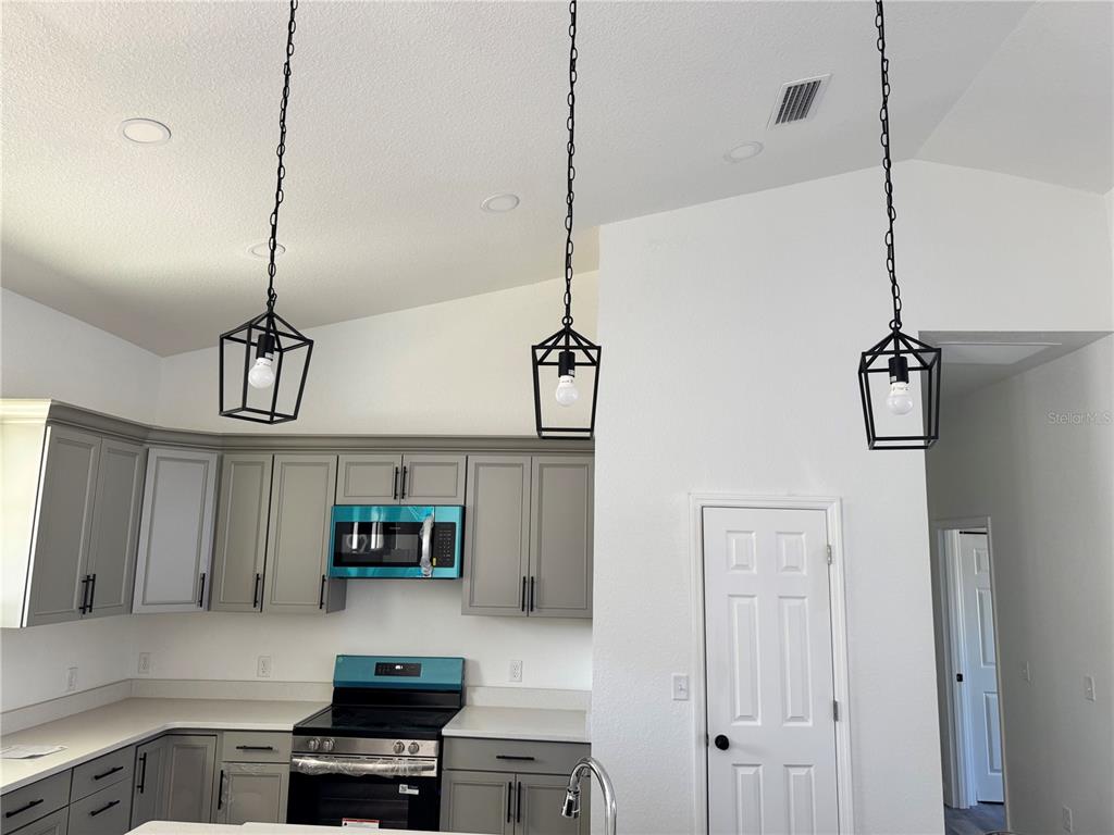 12757 Southeast 104th Terrace Belleview, FL 34420 - Photo 5 of 22 a kitchen with kitchen island a counter space a sink and appliances