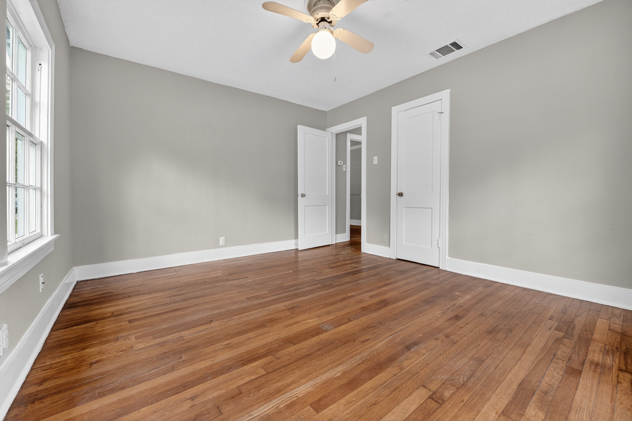 4907 Duval Street Austin, TX 78751 - Photo 23 of 31 wooden floor in an empty room with a window