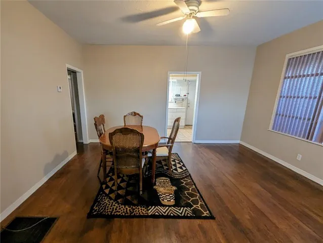a view of a workspace with furniture and wooden floor