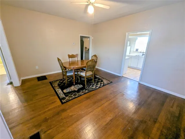a living room with wooden floor and a table