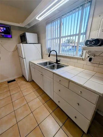 a kitchen with a sink cabinets and window