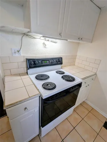 a stove top oven sitting inside of a kitchen