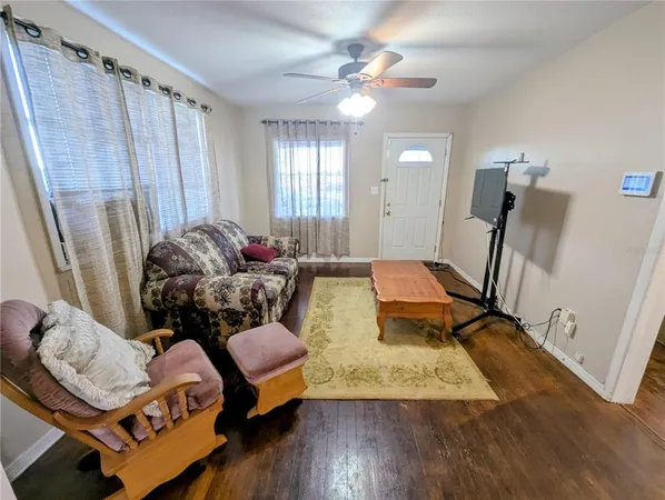 a living room with furniture and wooden floor