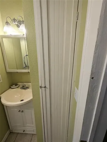 a bathroom with a sink a mirror and vanity