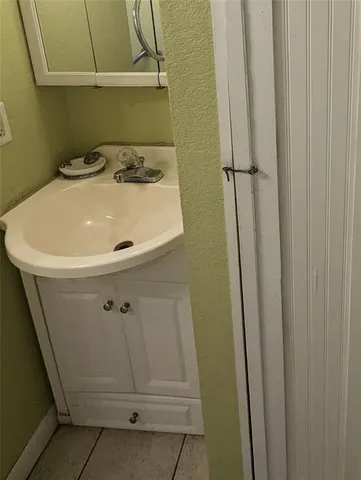 a bathroom with a sink and mirror