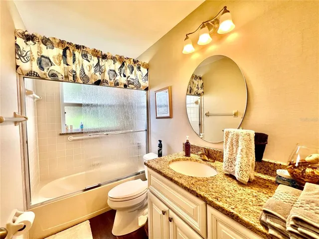 a view of a livingroom with workspace and a window