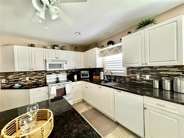 a kitchen with a stove a table and chairs in it