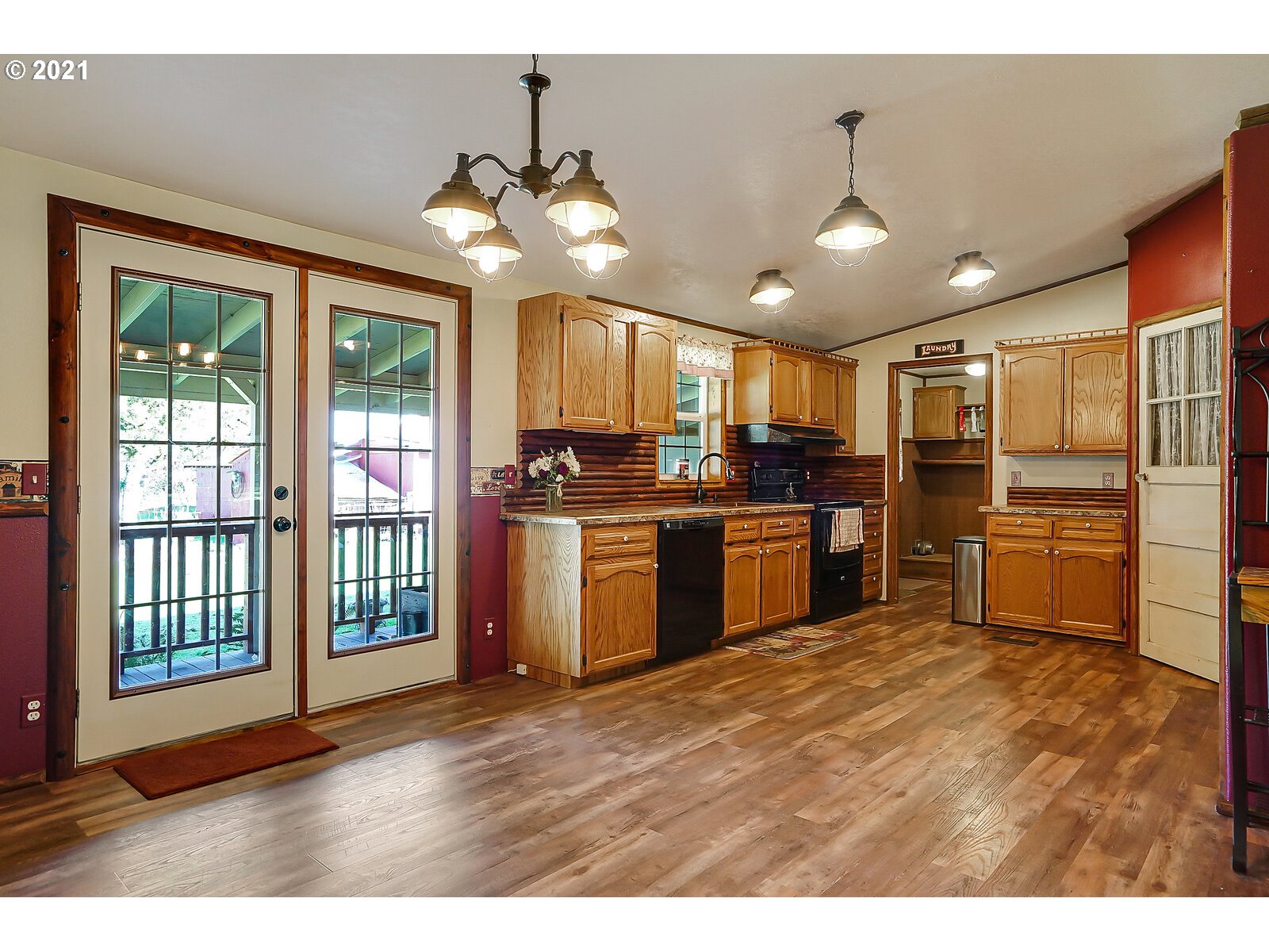 1725 Main Street Lyons, OR 97358 - Photo 11 of 32 a kitchen with stainless steel appliances kitchen island granite countertop a refrigerator a stove a sink and a view of living room