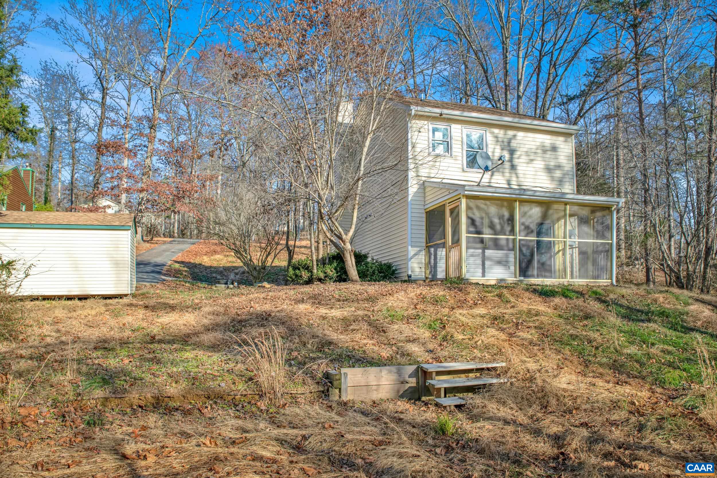 1100 West Daffodil Road Ruckersville, VA 22968 - Photo 3 of 27 a backyard of a house with large trees and outdoor seating