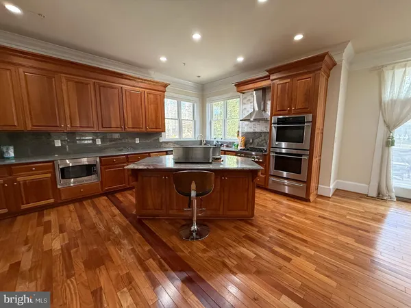 a view of a dining room with furniture and a chandelier