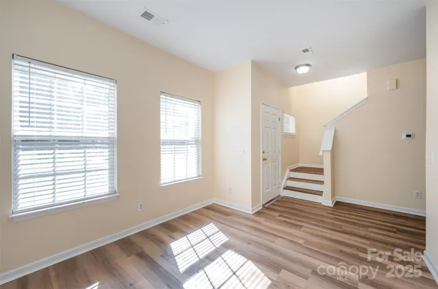 a view of wooden floor and windows in a room