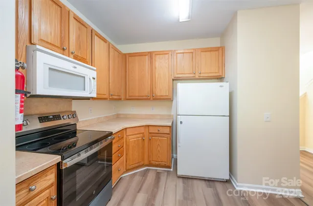a kitchen with a white cabinets and white appliances