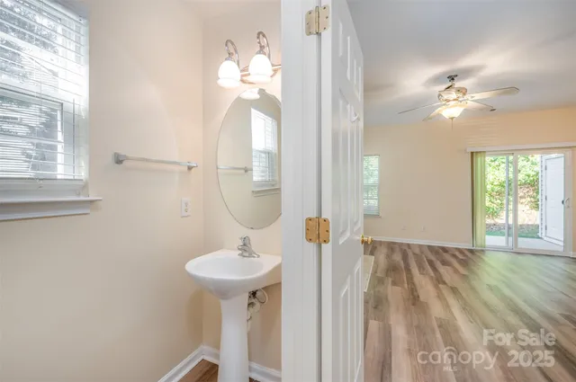 a bathroom with a sink a mirror and a window