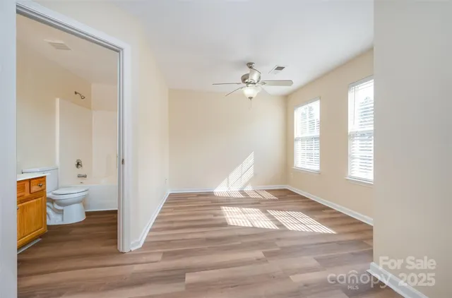 a view of a room that has a window and wooden floor