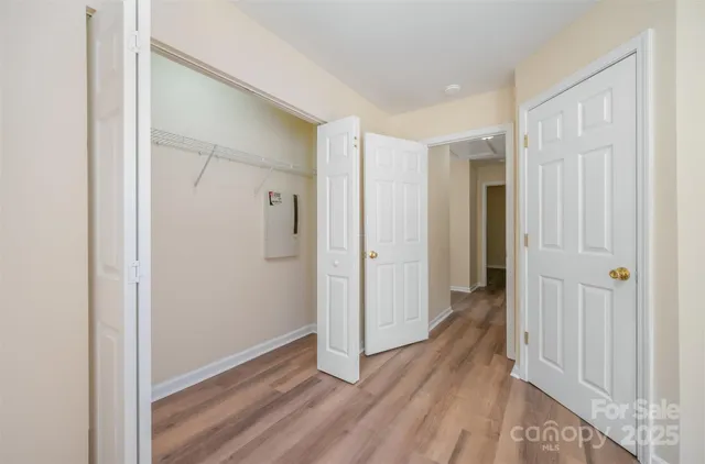 a view of a hallway with wooden floor