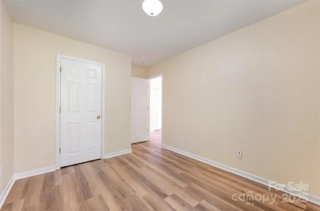 a view of room with window and hardwood floor