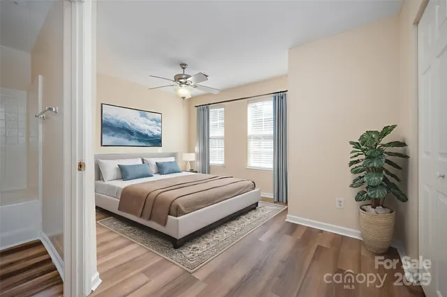 a bedroom with a large bed and a potted plant