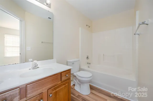 a bathroom with a sink toilet vanity and shower