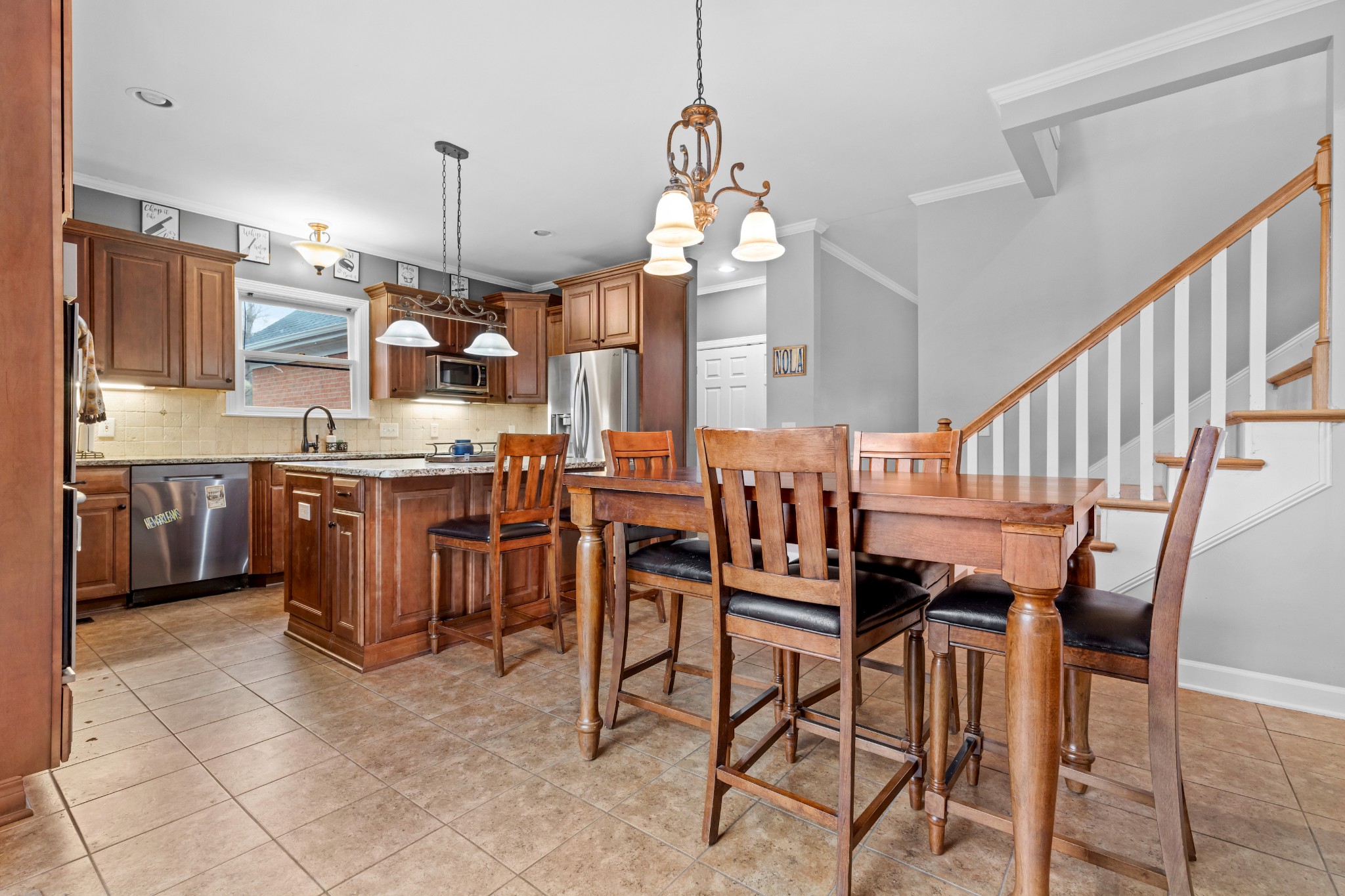 3354 Old Franklin Road Antioch, TN 37013 - Photo 23 of 46 a kitchen with stainless steel appliances kitchen island granite countertop a table chairs in it and wooden floors
