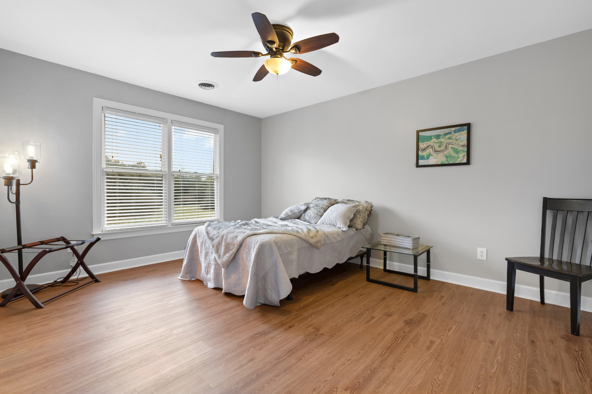3354 Old Franklin Road Antioch, TN 37013 - Photo 37 of 46 a bedroom with a bed and a table with wooden floor