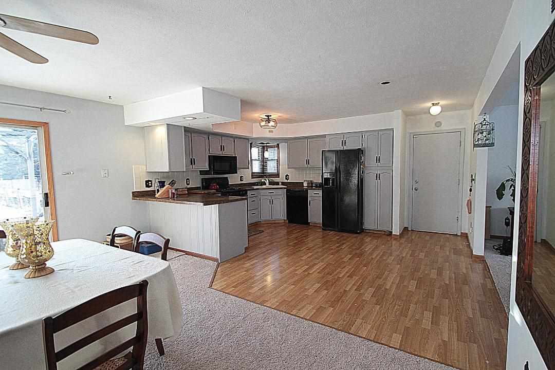 2911 Karr Road Belvidere, IL 61008 - Photo 2 of 19 a kitchen with stainless steel appliances kitchen island granite countertop a refrigerator and a stove top oven