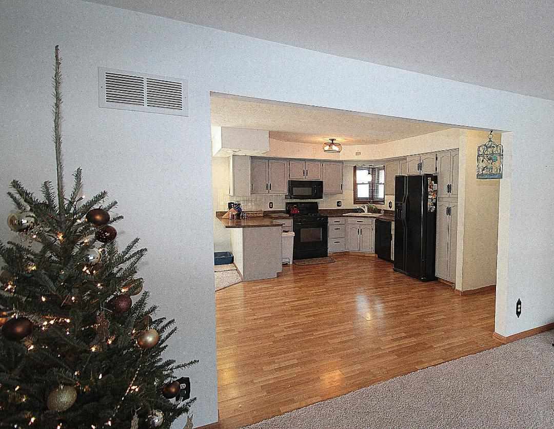 2911 Karr Road Belvidere, IL 61008 - Photo 3 of 19 a kitchen with granite countertop a refrigerator and a stove top oven
