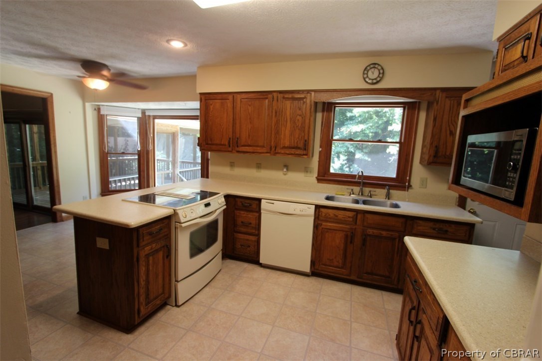 308 Tides Run Yorktown, VA 23692 - Photo 6 of 34 a kitchen with stainless steel appliances granite countertop a stove a sink and a microwave